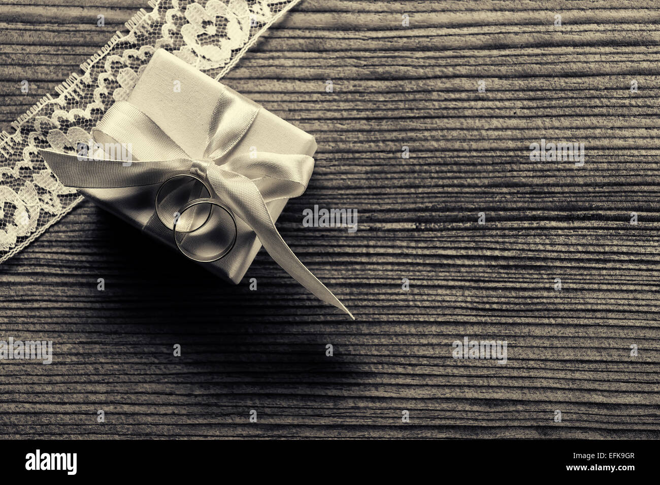 Engagement ring with gift box, white lace - wood background Stock Photo