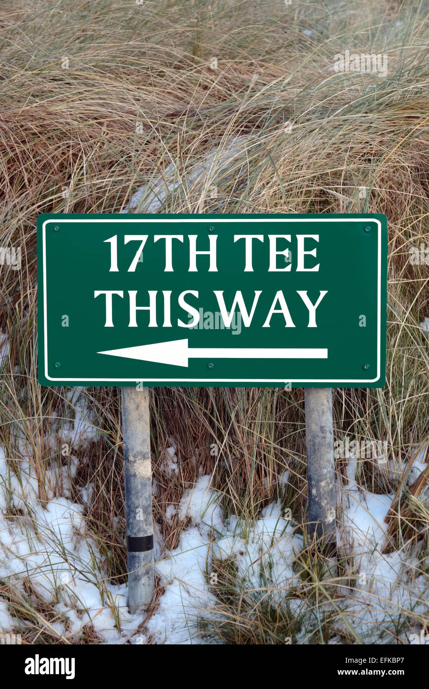 the 17th tee this way sign on an irish golf course in the winters snow Stock Photo