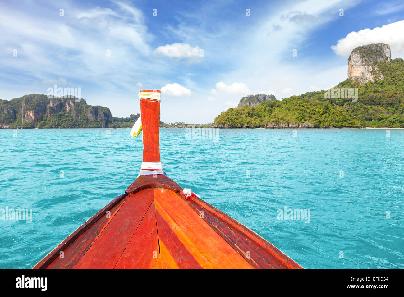 Wooden boat and a tropical island in distance. Stock Photo