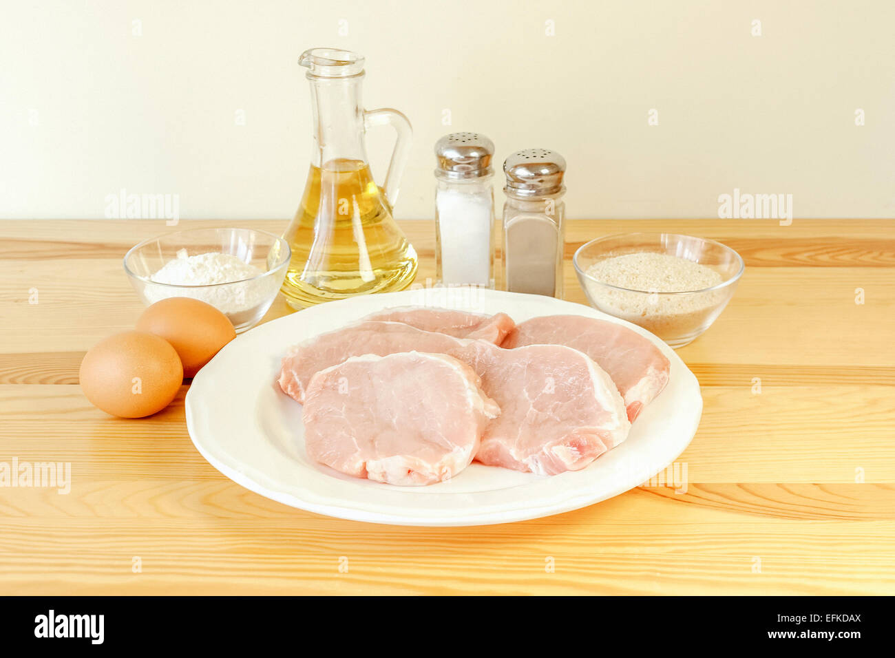 Preparing pork schnitzel ingredients pork loin chops, eggs, salt