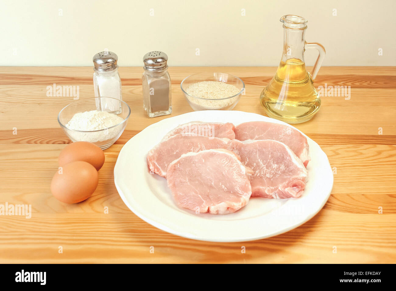 Preparing pork schnitzel ingredients pork loin chops, eggs, salt