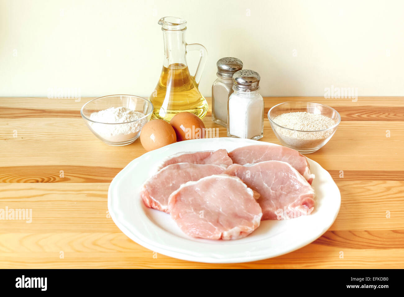 Preparing pork schnitzel ingredients pork loin chops, eggs, salt