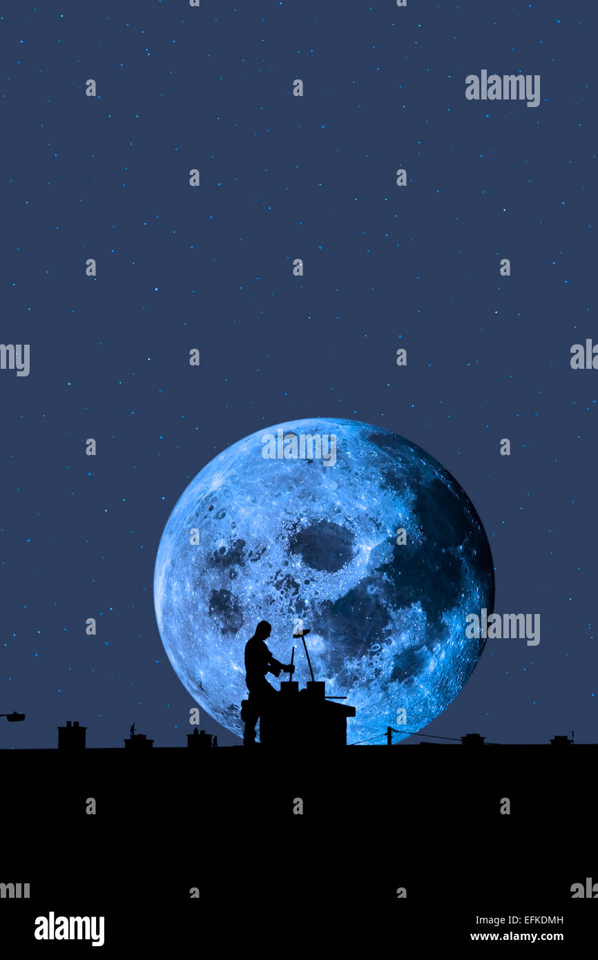 silhouette of a chimney sweep at work on the rooftop of a housing estate with moonlit sky in background Stock Photo