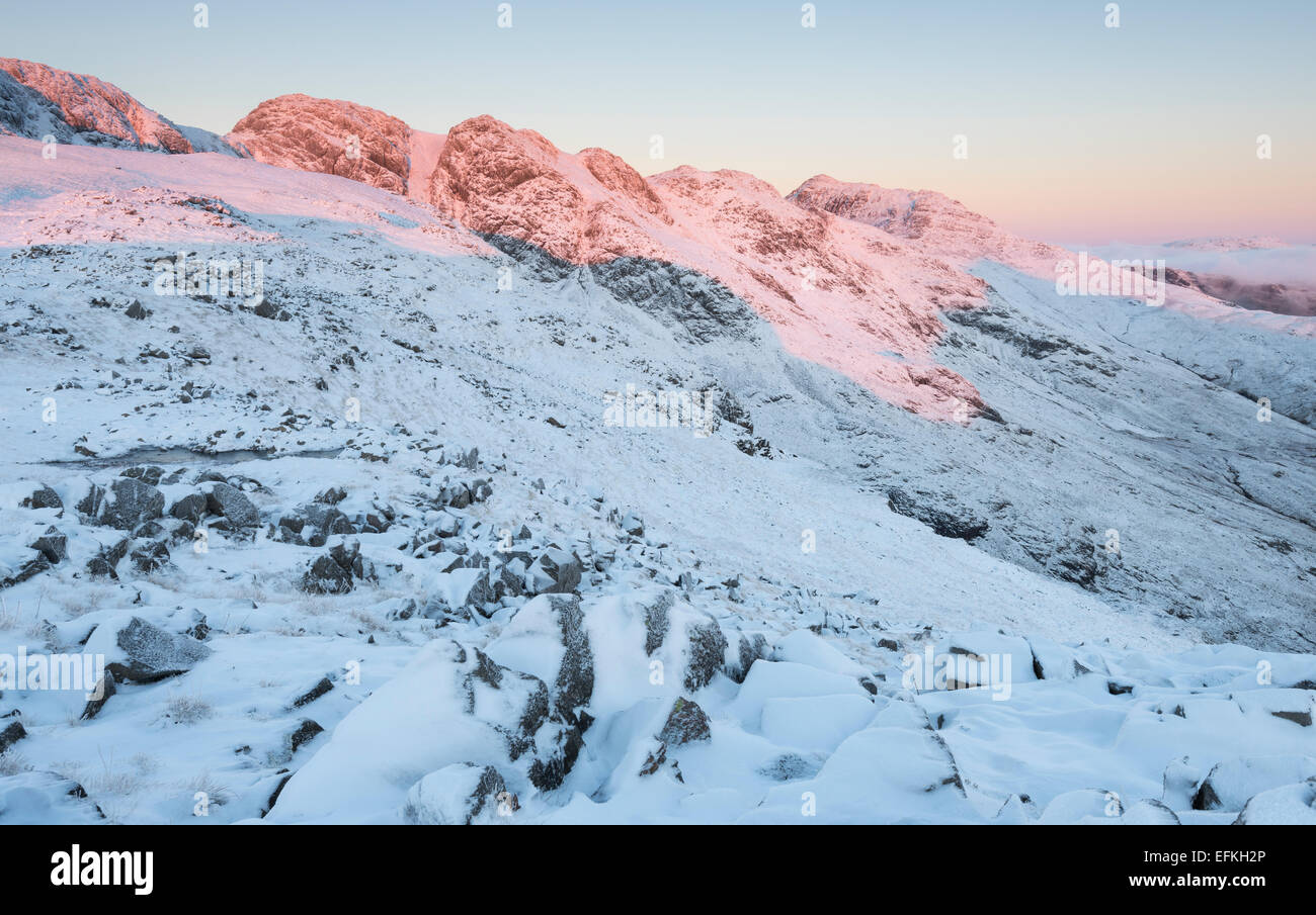 Danw pink light on Crinkle Crags and Bowfell, English Lake District national park Stock Photo