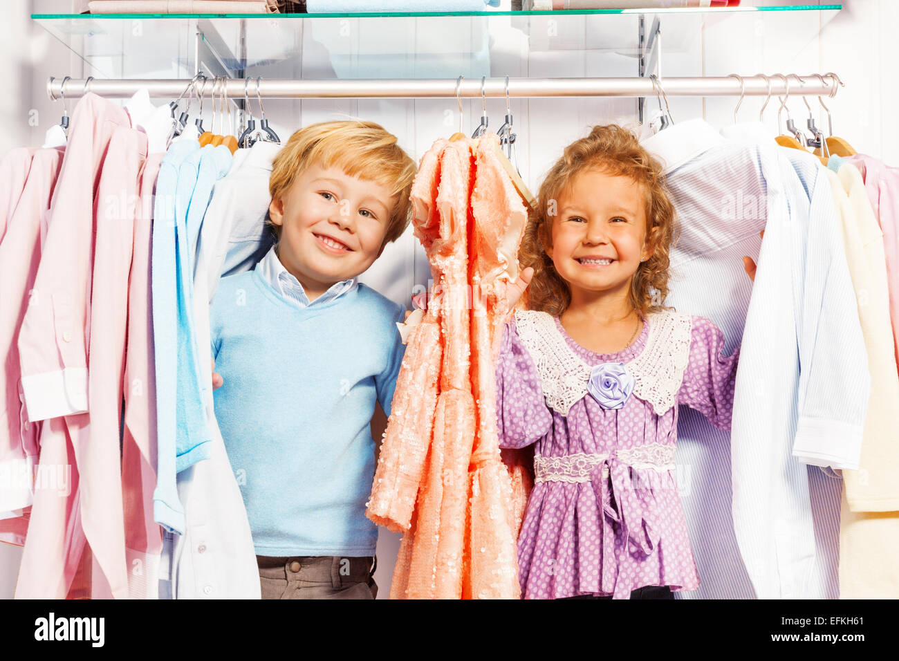 Boy and girl play hide-and-seek in clothes Stock Photo - Alamy