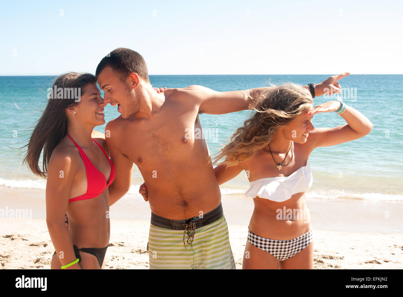 Teenage boy cheating girlfriend on the beach Stock Photo