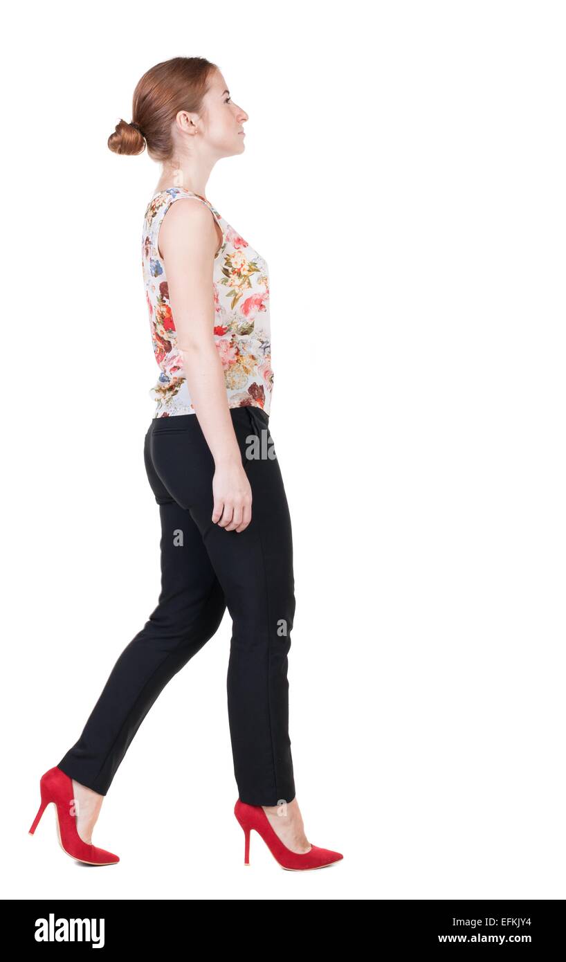 walking red head business woman. back view. going young girl in suit ...