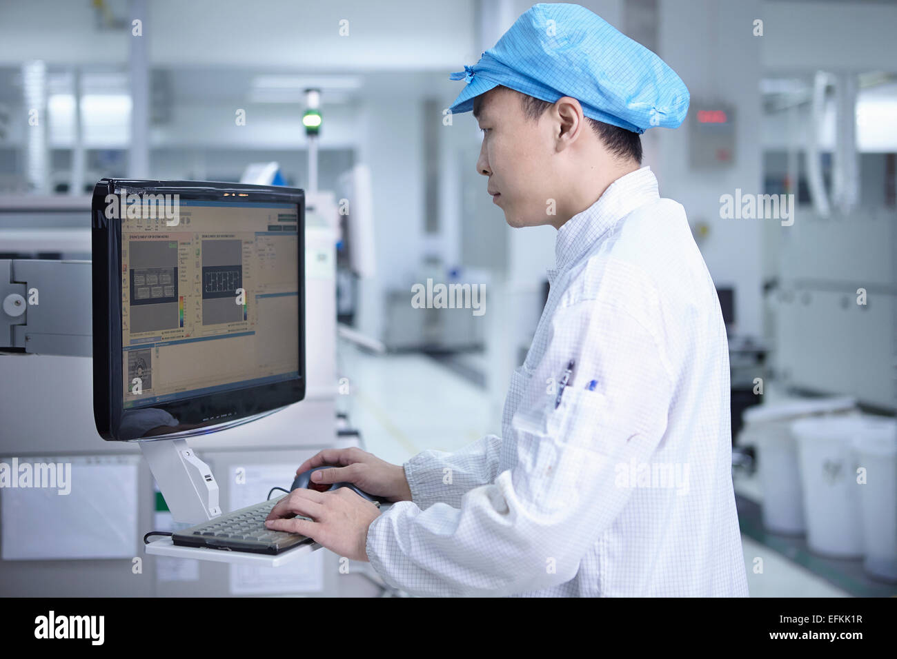 Worker using computer in factory that specialises in creating ...