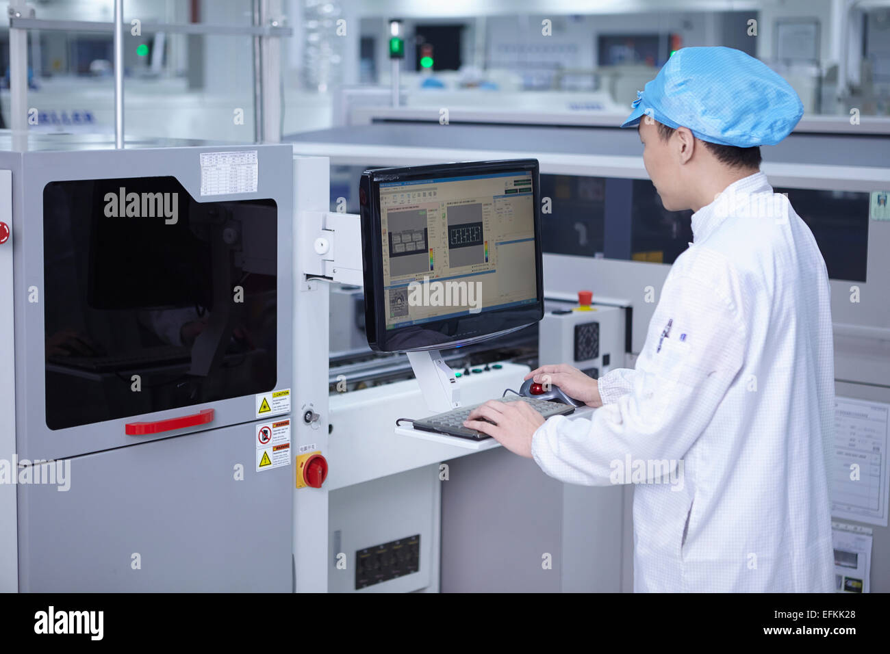 Worker using computer in factory that specialises in creating ...