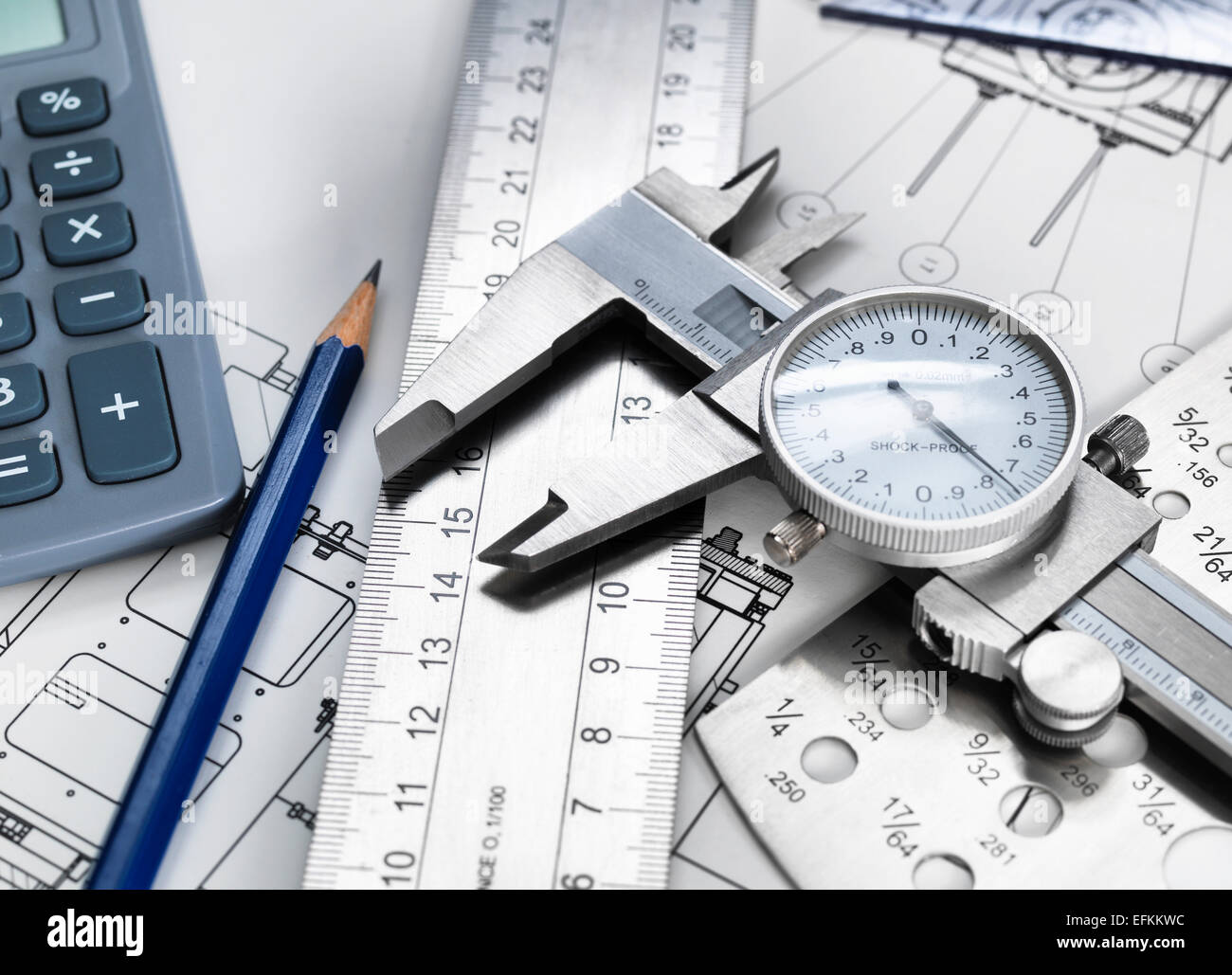 Dial caliper and engineering measurement equipment, sitting on technical drawing Stock Photo