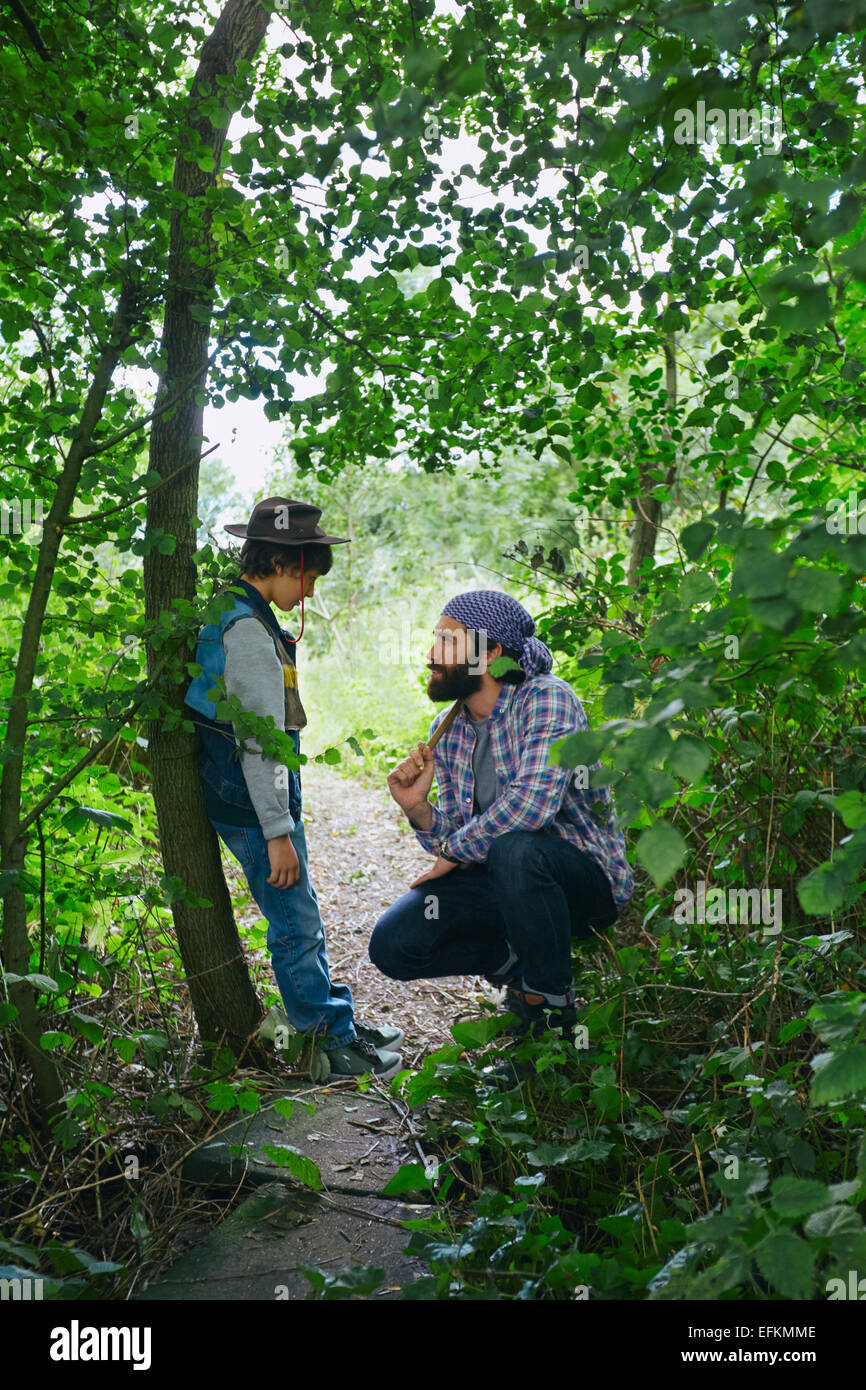 Father advising son in forest Stock Photo - Alamy