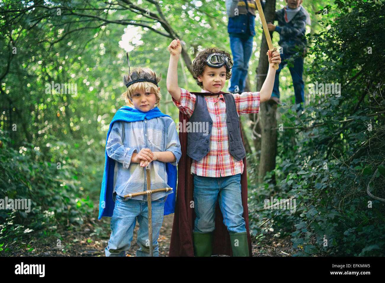 Two boys dressed up and playing in forest Stock Photo