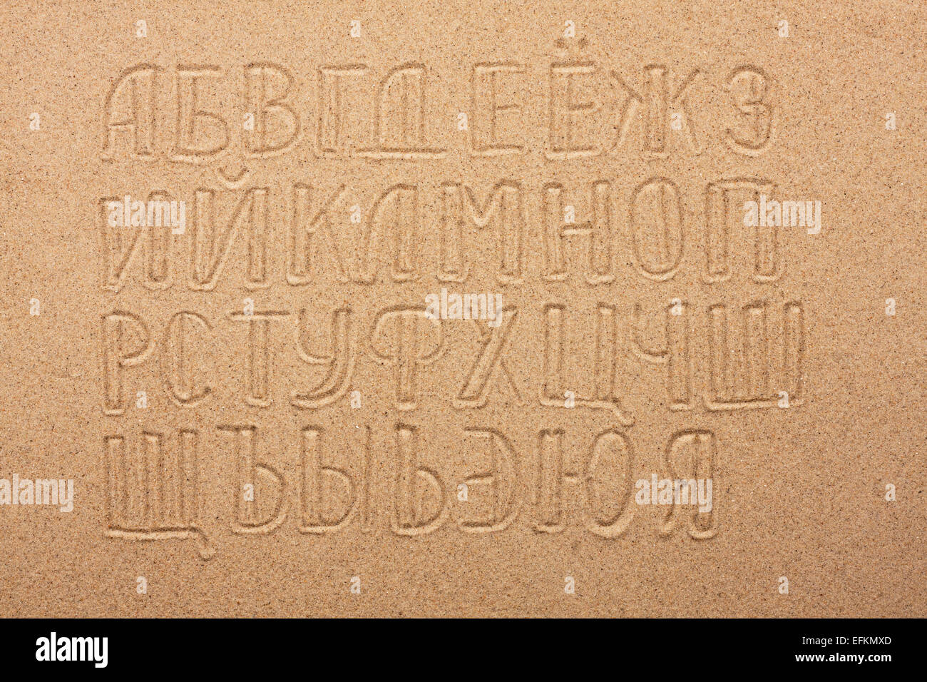 Russian alphabet  written on the sand, as background Stock Photo