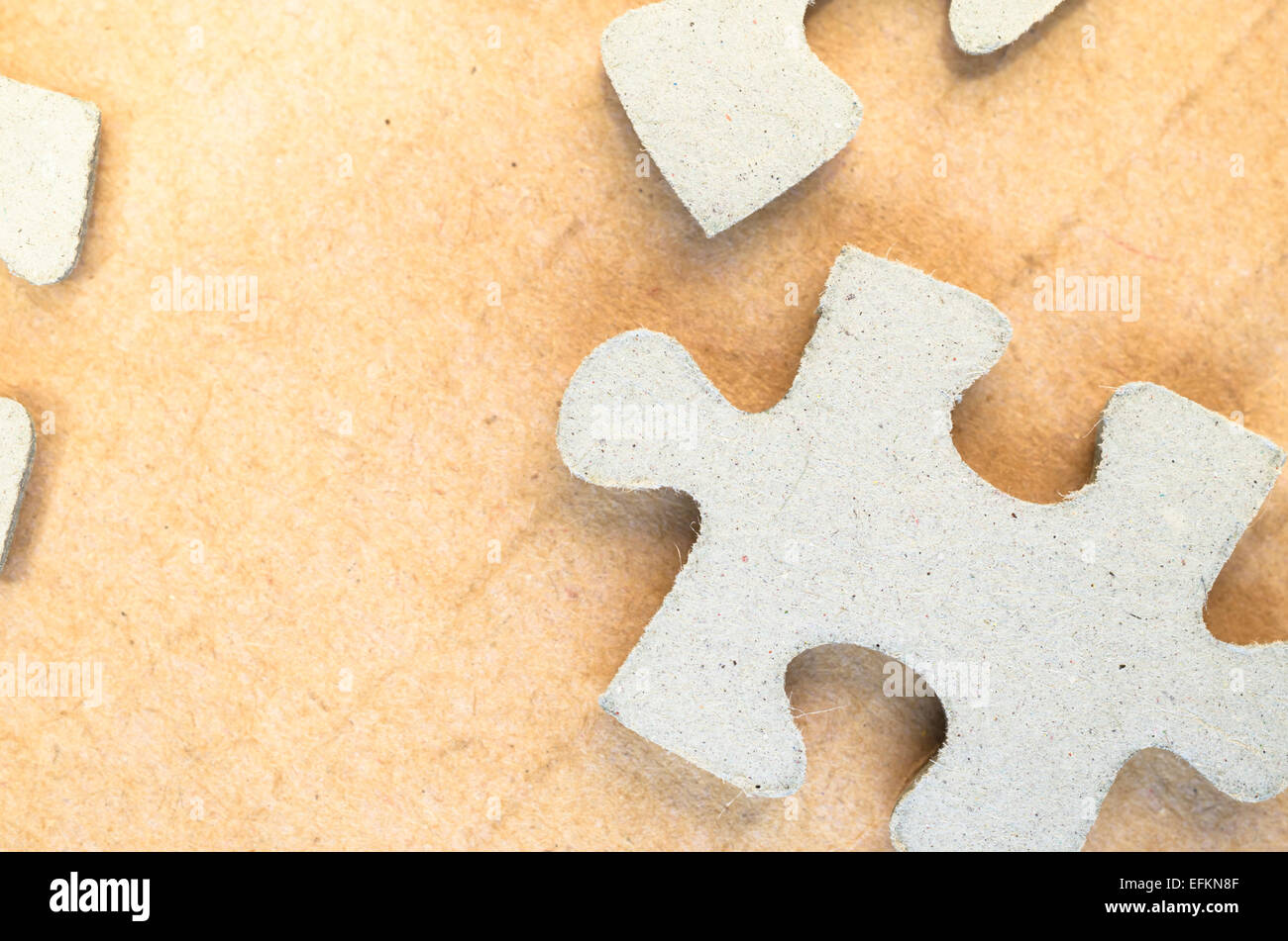 jigsaw puzzle pieces on a paperboard surface Stock Photo