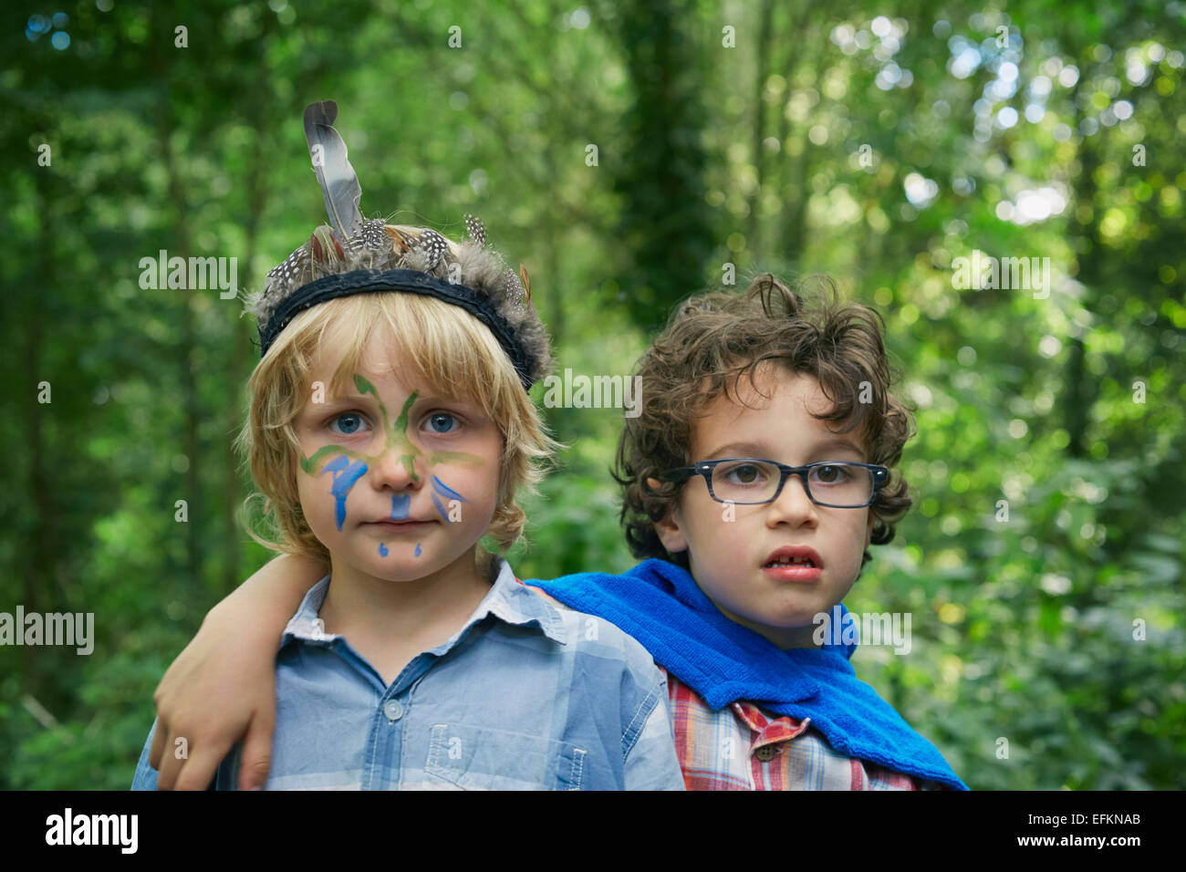 Portrait of two boys in forest with face paint Stock Photo