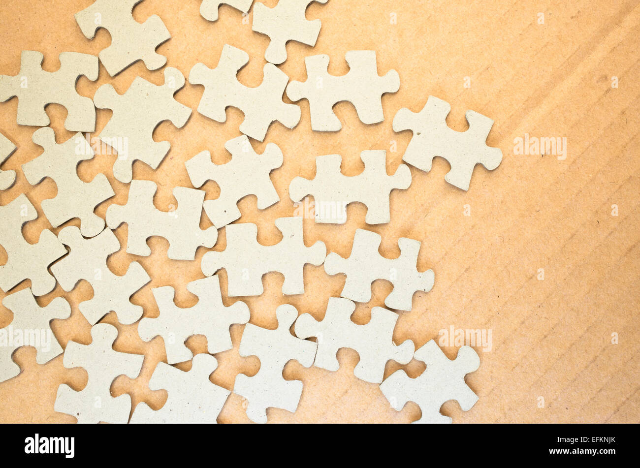 many jigsaw puzzle pieces on a paperboard surface Stock Photo Alamy