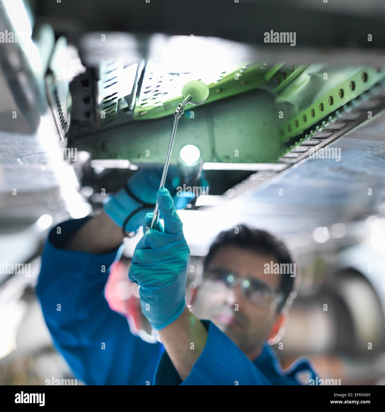 Engineer working on aircraft wing in aircraft maintenance factory, close up Stock Photo