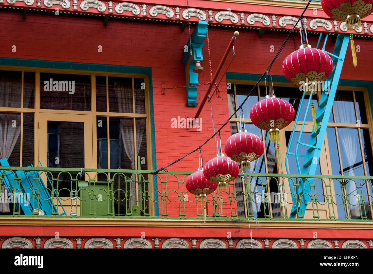 Brightly colored building with a string of Chinese lanterns on Grant in