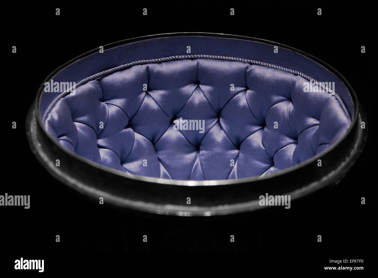 Hemispherical container for precious objects upholstered with blue satin Stock Photo