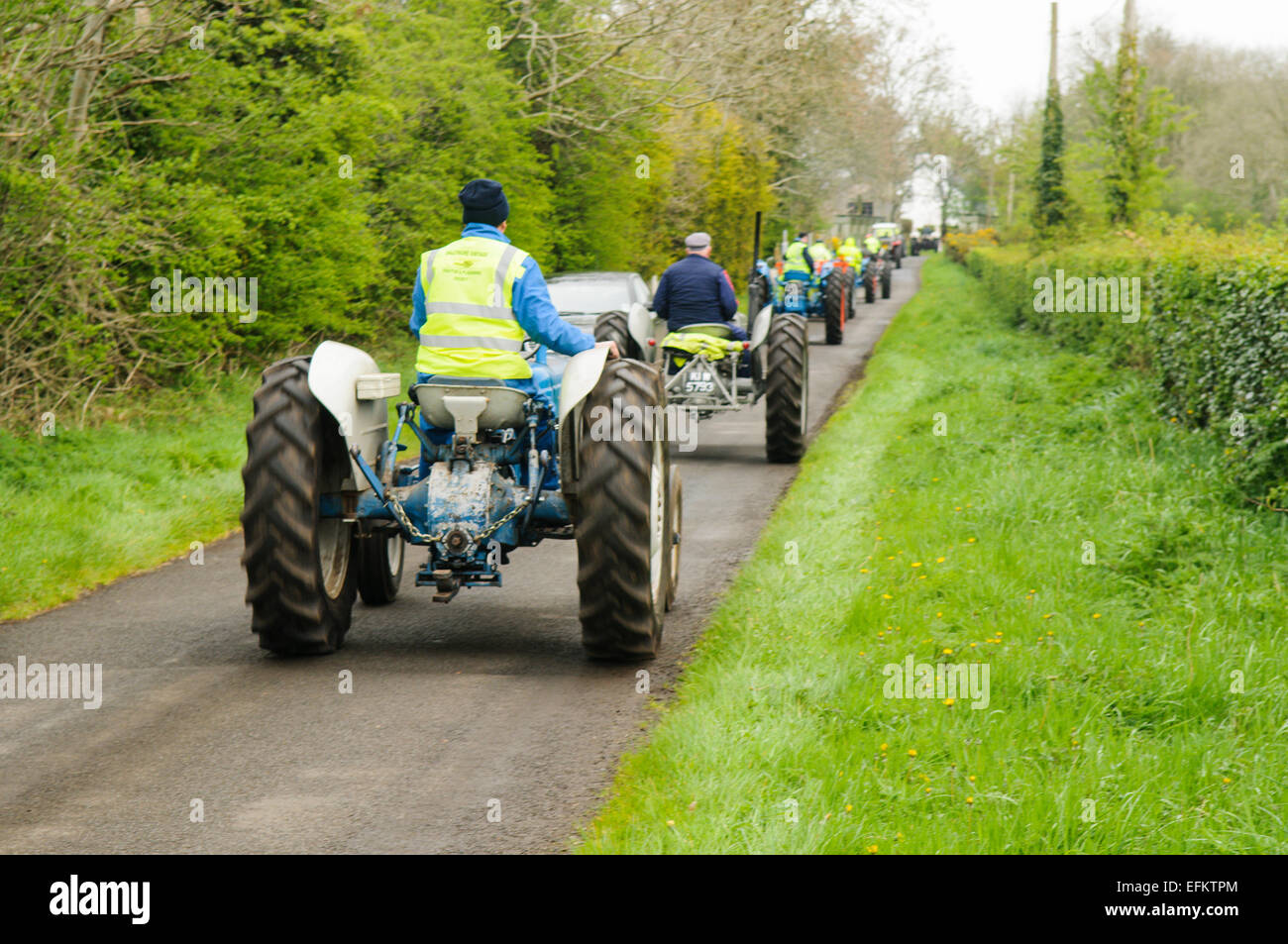 long-line-of-tractors-on-a-country-road-