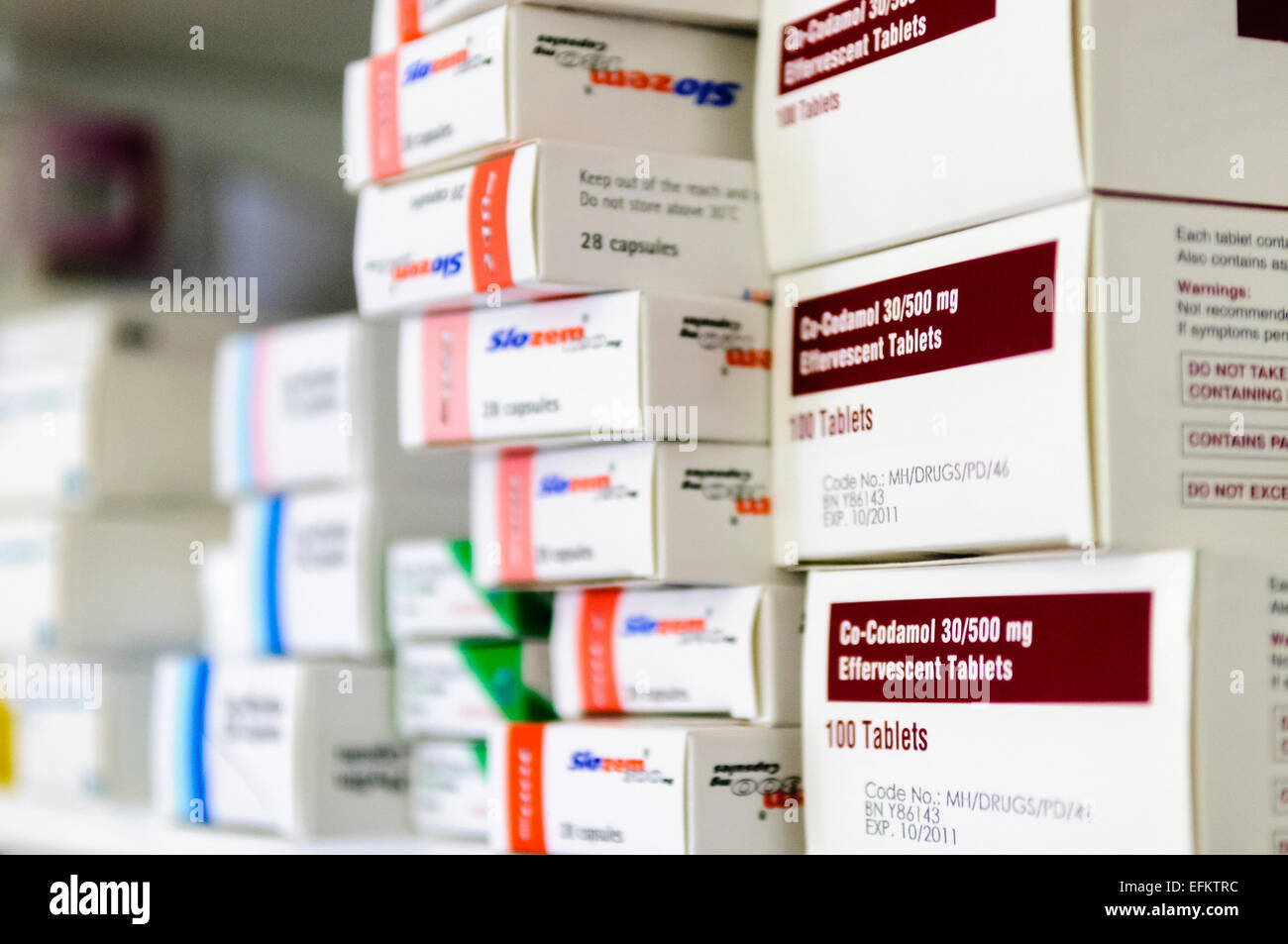 Co-codamol and other tablets stacked on a shelf at a pharmacy Stock Photo