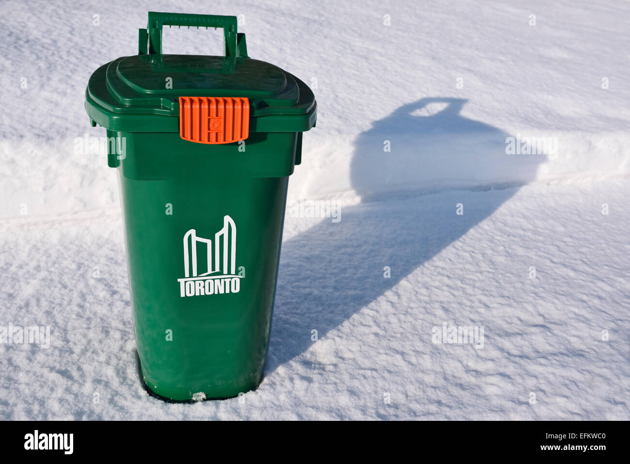 New Toronto green bin recycling on fresh snow covered sidewalk in winter Stock Photo