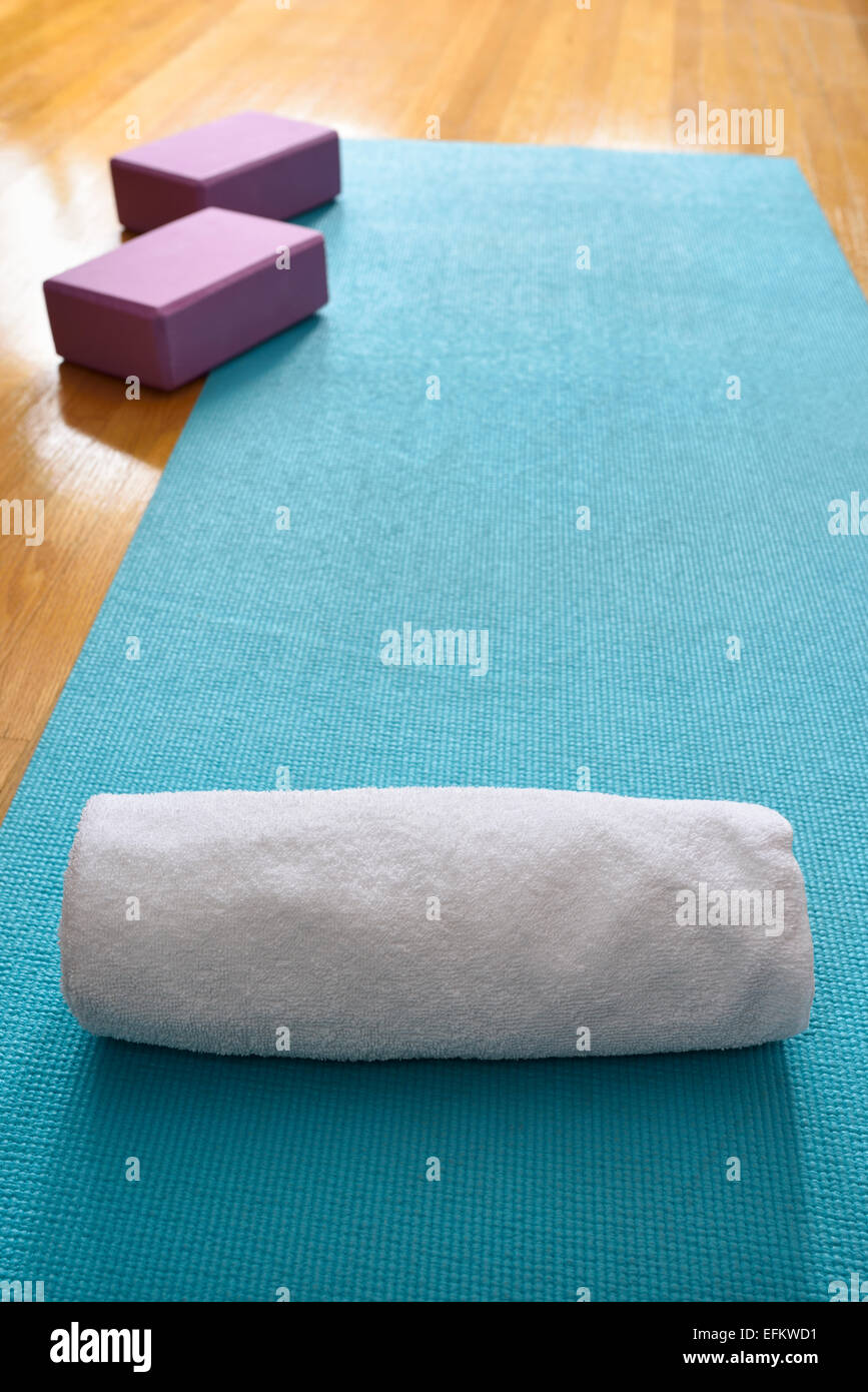 Blue Yoga Mat In Gym Exercise Studio With Fresh Towel And Purple