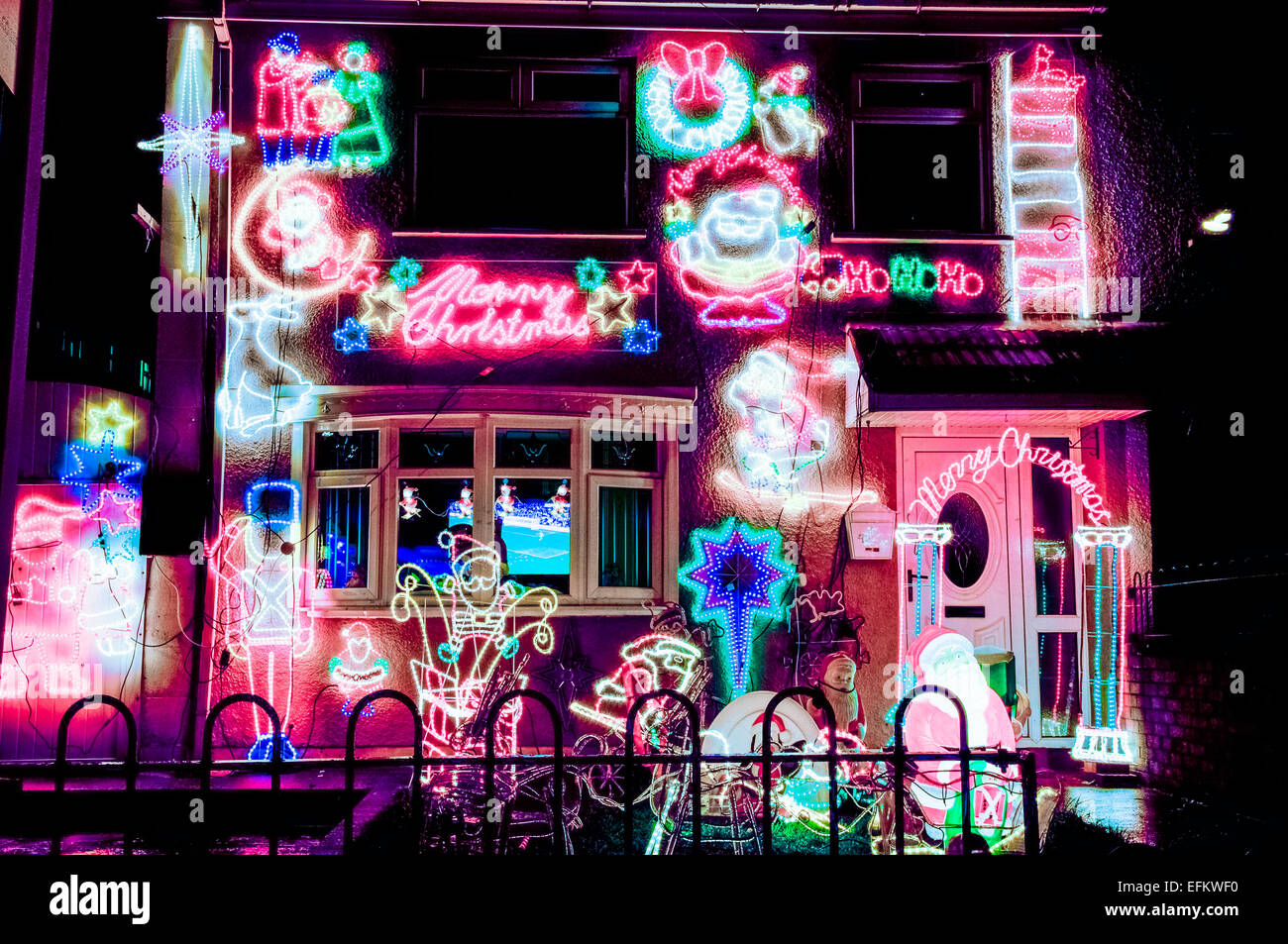 A small house is festooned with Christmas lights Stock Photo Alamy