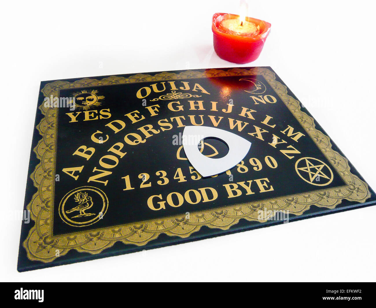 Ouija board with a candle Stock Photo