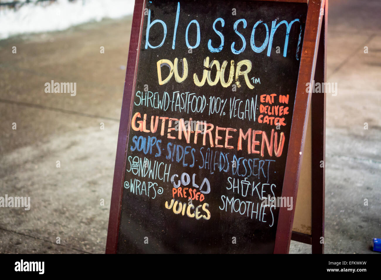 A sign outside of a the Blossom du Jour restaurant in New York on Tuesday, February 3, 2015 promotes their vegan and gluten-free menu. The protein gluten is found in wheat and is a flavoring and thickening food additive. People with celiac disease, dermatitis herpetiformis  and wheat allergies eat a gluten-free diet to prevent their disease or allergy. (© Richard B. Levine) Stock Photo
