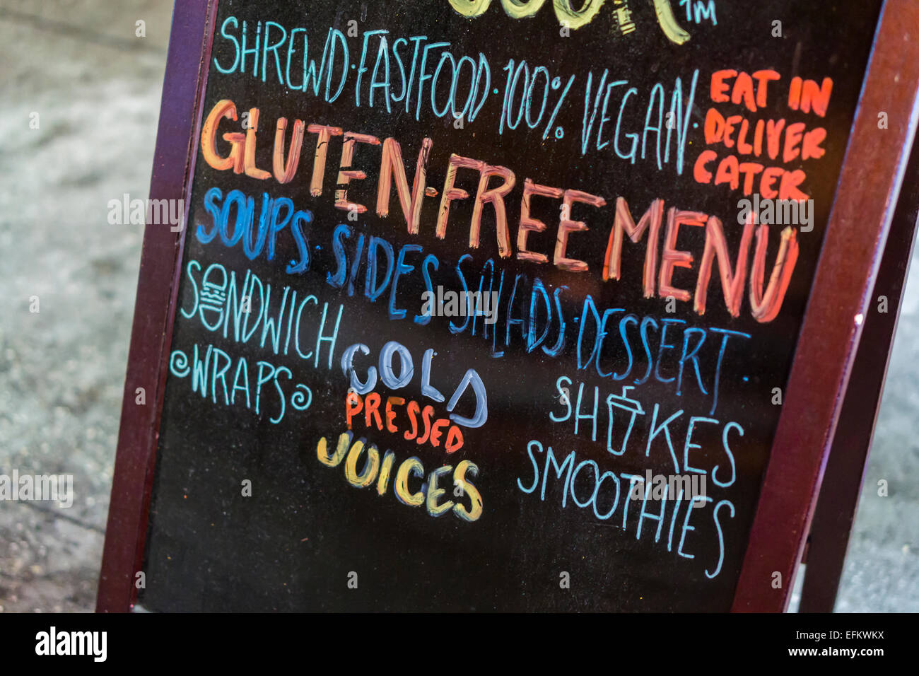 A sign outside of a the Blossom du Jour restaurant in New York on Tuesday, February 3, 2015 promotes their vegan and gluten-free menu. The protein gluten is found in wheat and is a flavoring and thickening food additive. People with celiac disease, dermatitis herpetiformis  and wheat allergies eat a gluten-free diet to prevent their disease or allergy. (© Richard B. Levine) Stock Photo