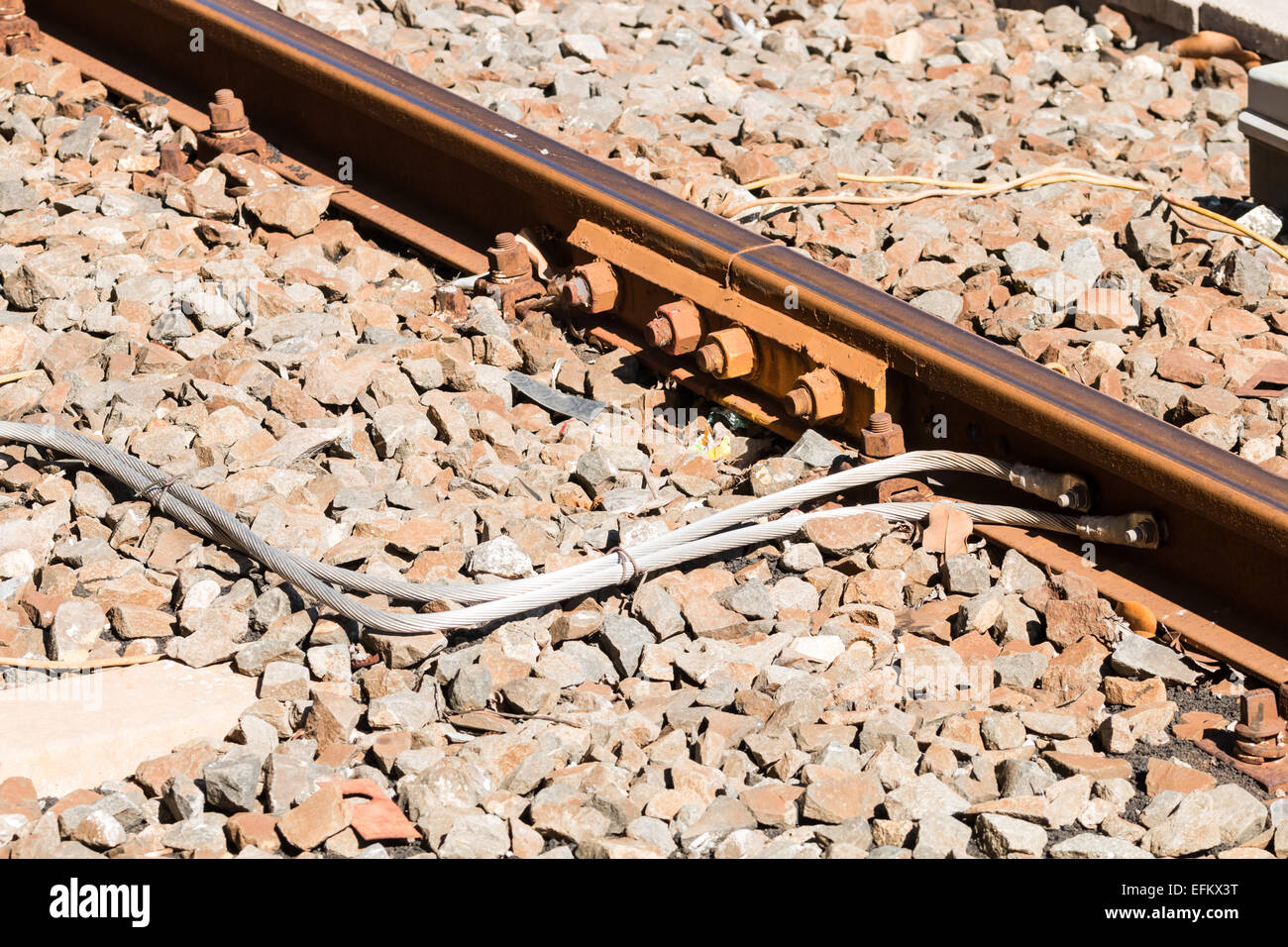 Electrical power connections between the train tracks Stock Photo Alamy