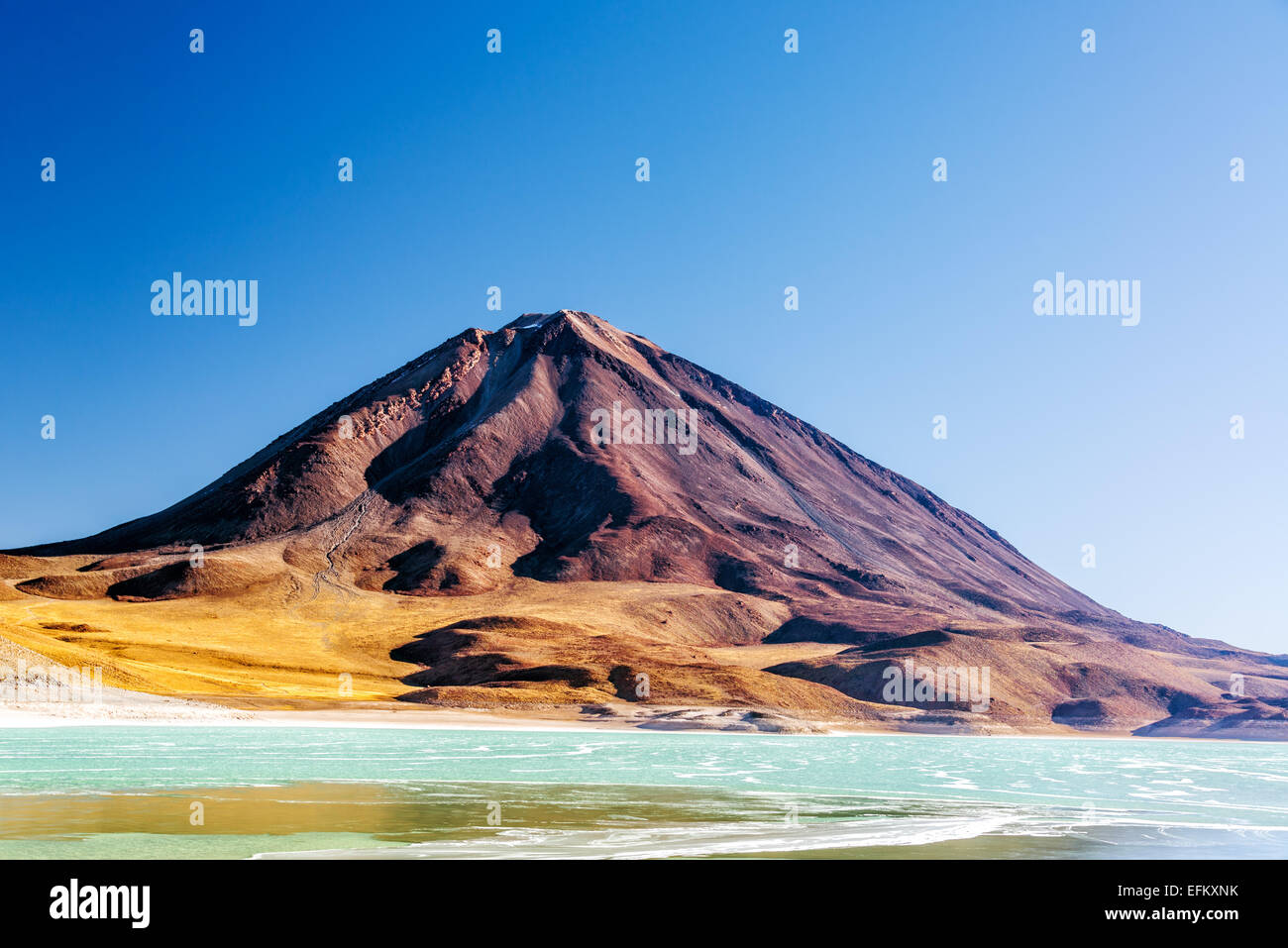 View of Licancabur Volcano and the emerald green Laguna Verde on the border of Chile and Bolivia Stock Photo