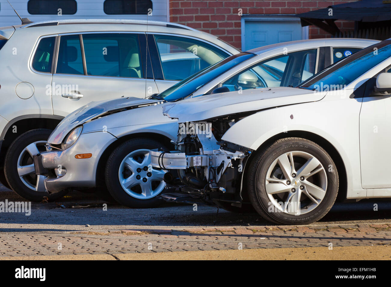 Car with front end collision damage at auto body repair shop - USA Stock Photo