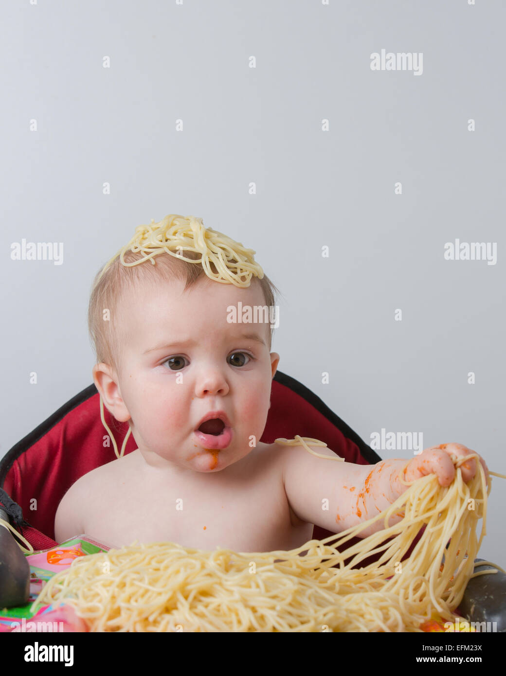 12 month old baby eating pasta Stock Photo Alamy