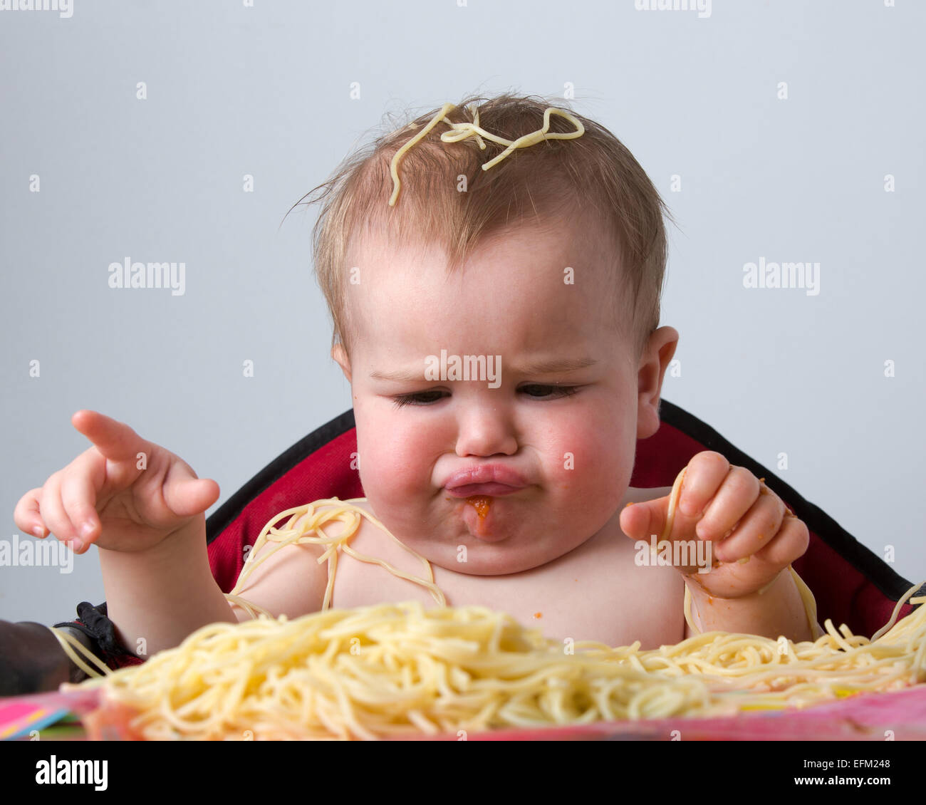 12 month old baby eating pasta Stock Photo Alamy
