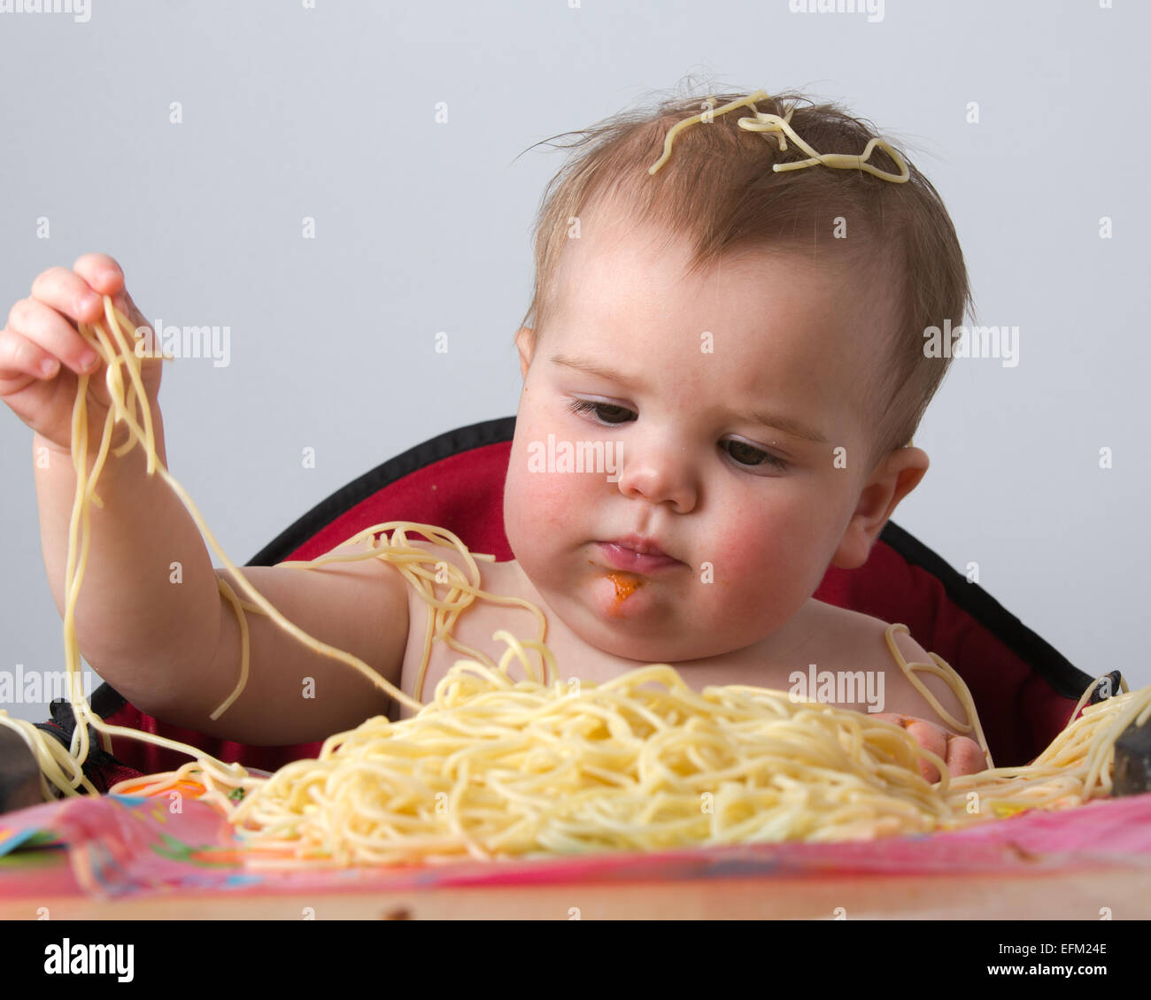 12 month old baby eating pasta Stock Photo Alamy