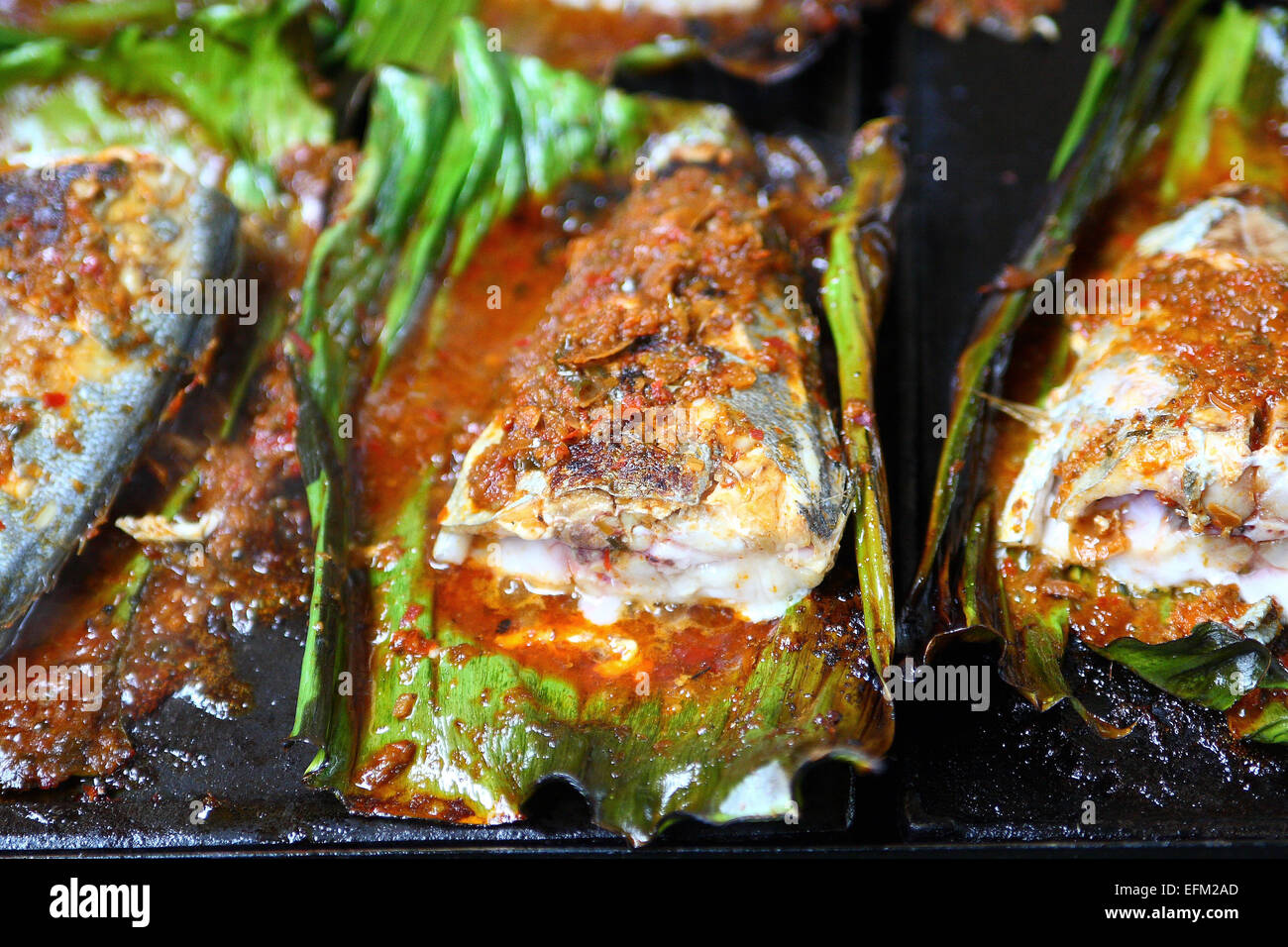 Grilled Fish Wrapped in Banana Leaf Stock Photo