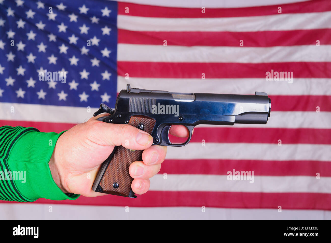 Closeup of a Lefthanded shooter holding semiautomatic pistol in