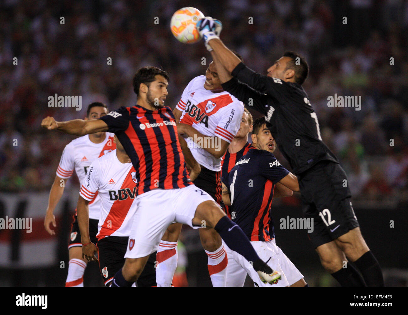 Buenos Aires, Argentina. 6th Feb, 2015. River Plate's Teofilo Gutierrez (C) vies with San Lorenzo's Emanuel Mas (L) and goalkeeper Sebastian Torrico during the match of the South American Recopa in Buenos Aires, Argentina, Feb. 6, 2015. River Plate won 1-0. © Martin Zabala/Xinhua/Alamy Live News Stock Photo