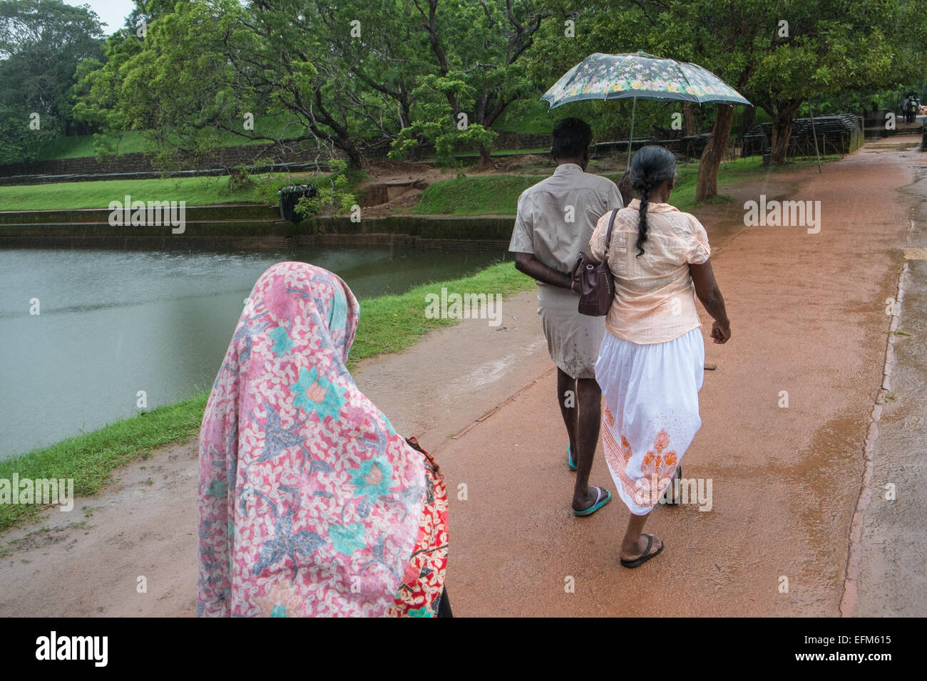 Locals with umbrella during heavy rainfall,rainy season monsoon rain at