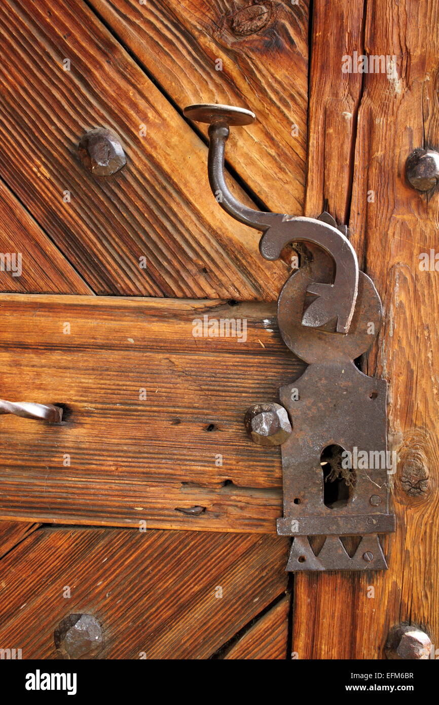 ancient latch on beautiful wooden door, entrance detail of old romanian traditional church Stock Photo