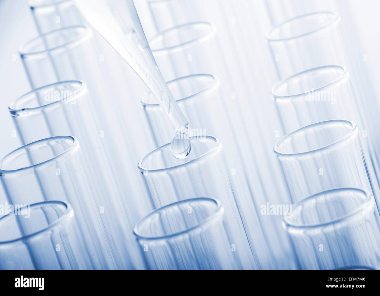 Test tubes and glass pipette on a blue background. Toned image Stock ...
