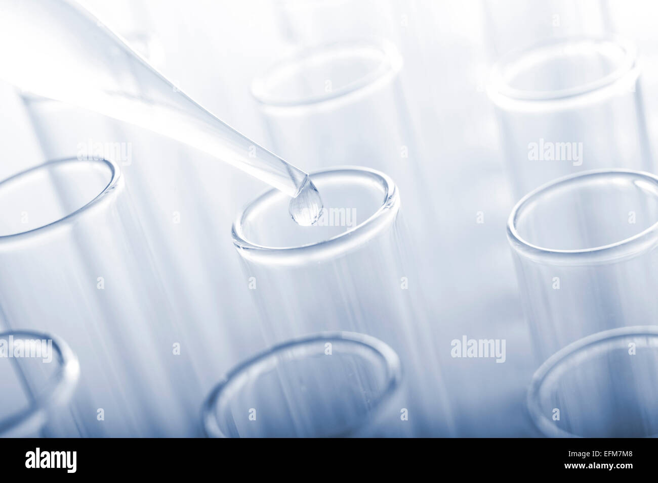 Test tubes and glass pipette on a blue background. Toned image Stock ...