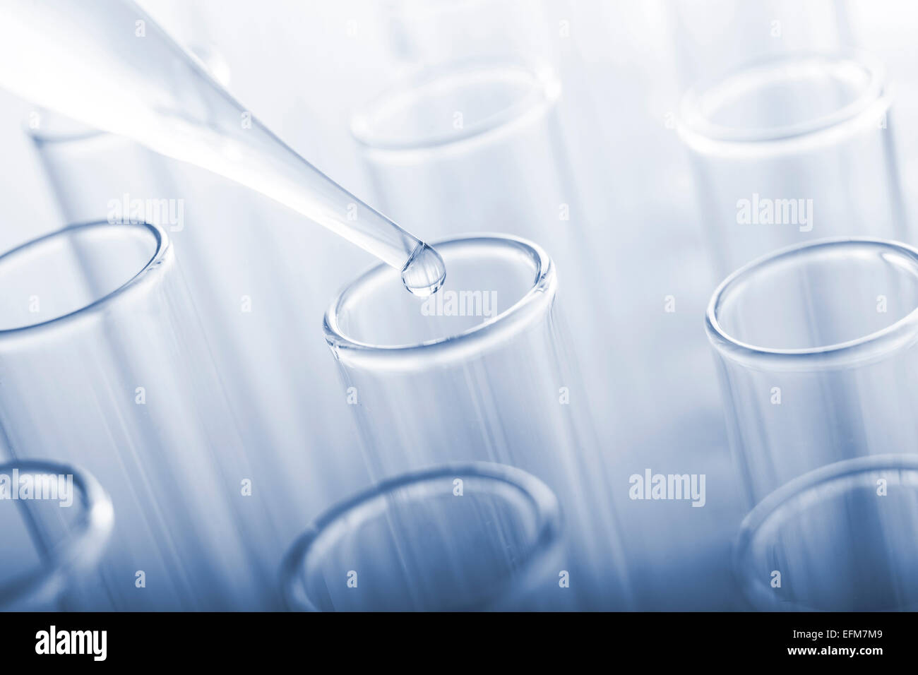 Test tubes and glass pipette on a blue background. Toned image Stock ...