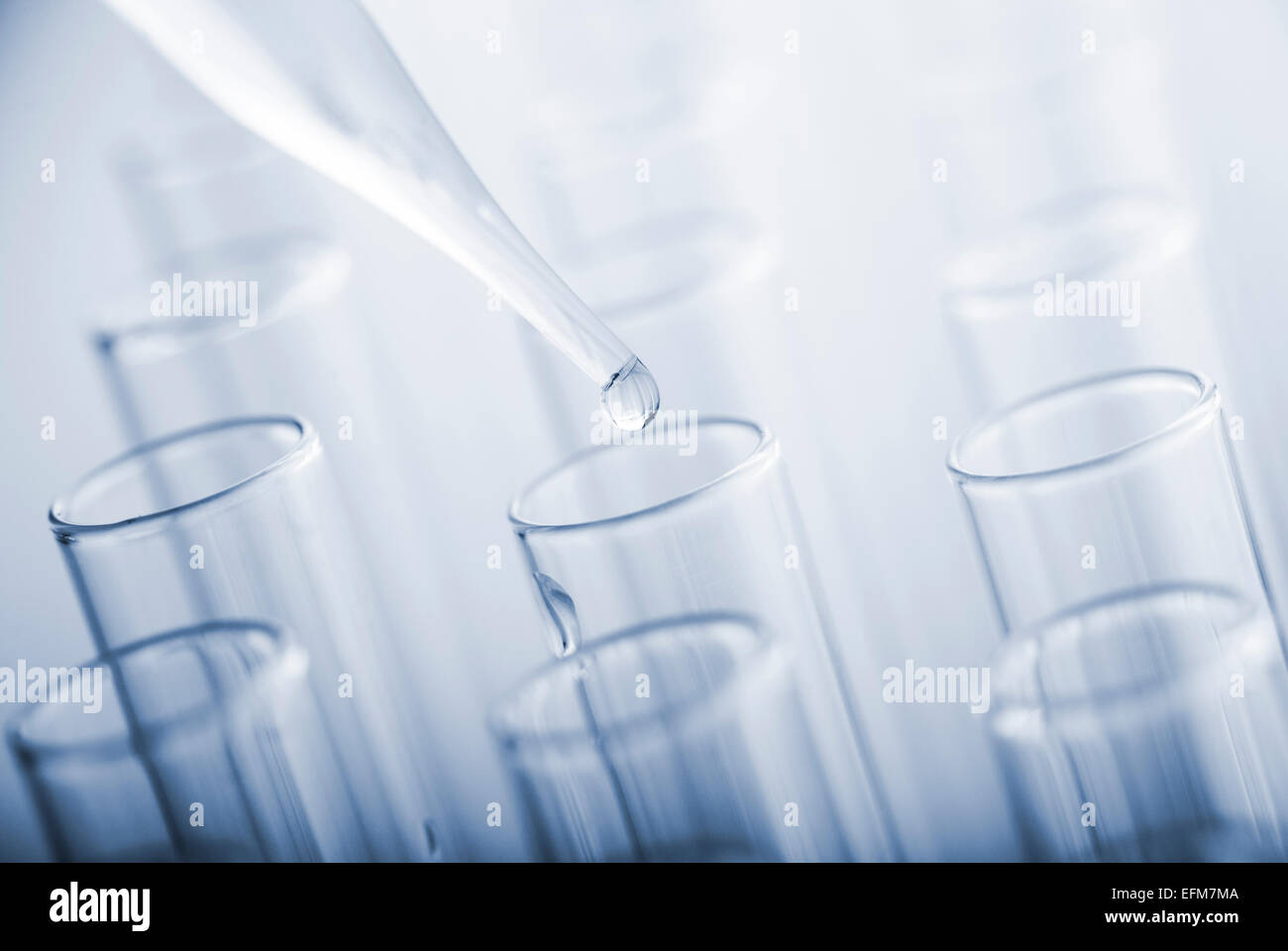 Test tubes and glass pipette on a blue background. Toned image Stock ...