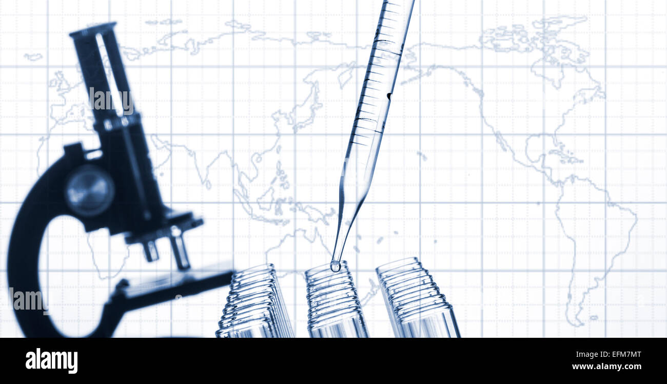 Closeup of glass test tubes and laboratory microscope on a world map ...
