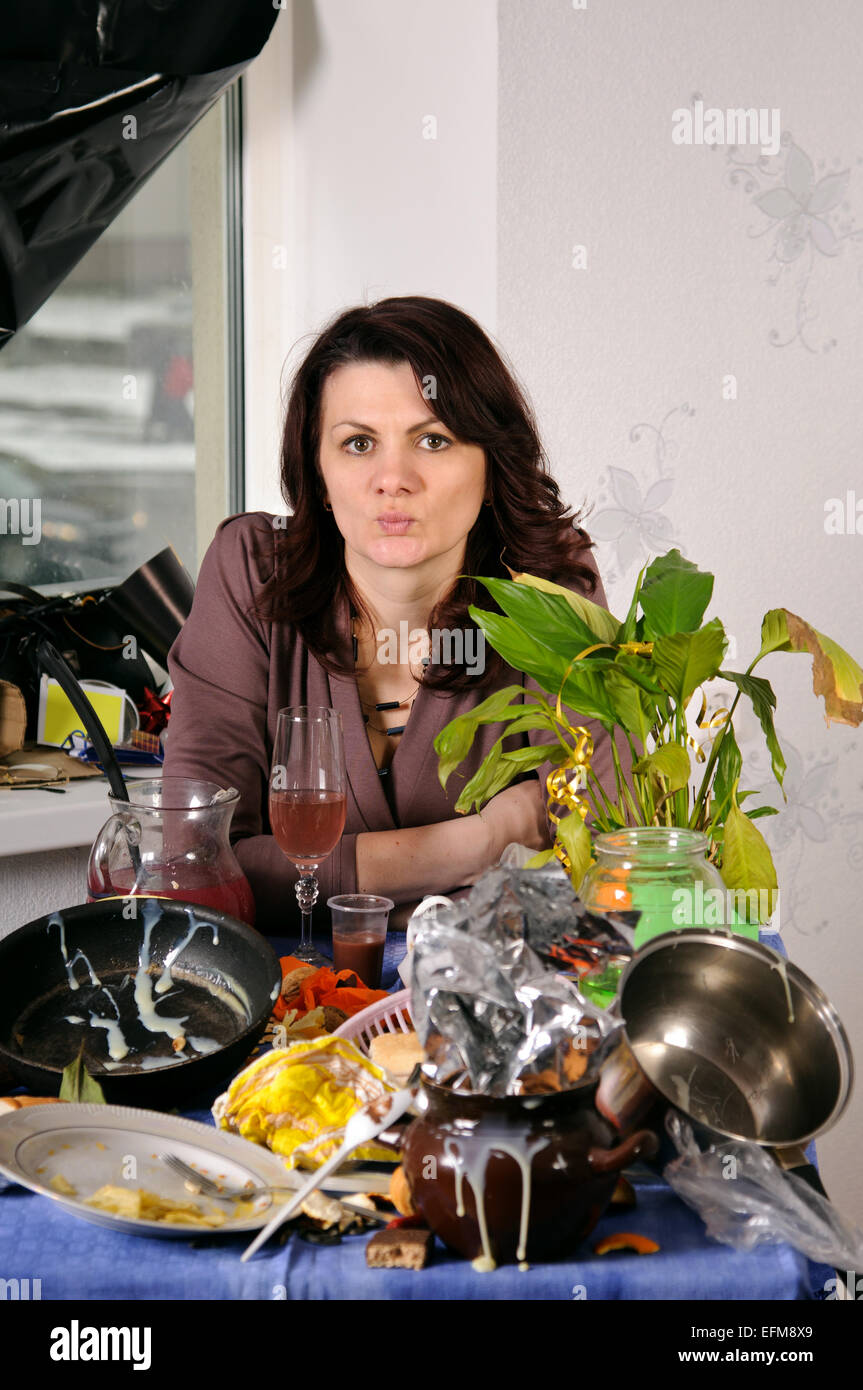 sad woman  behind a dirty table Stock Photo