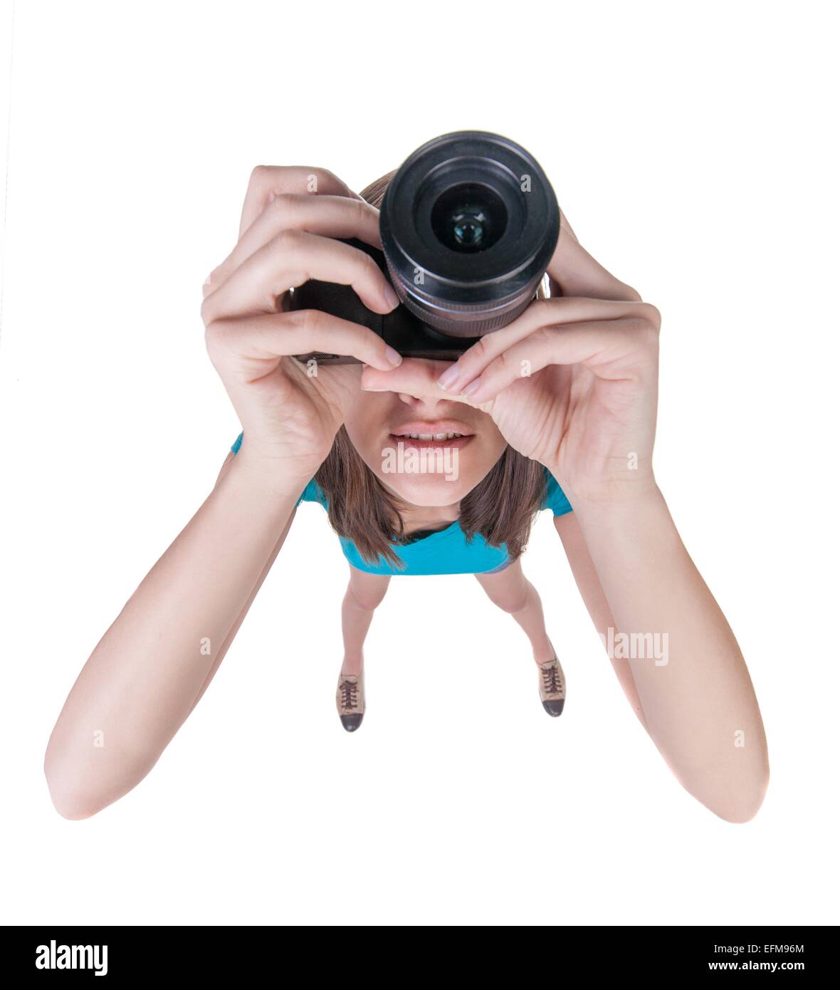 young woman in shorts photographed something compact camera. Isolated over white background. Stock Photo