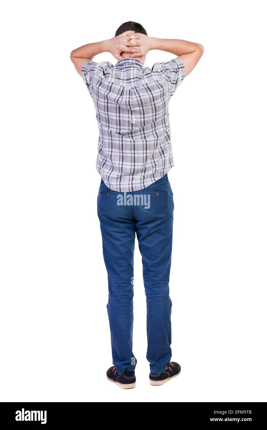 Back view of handsome man in shirt looking up.   Standing young guy in jeans. Rear view people collection.  backside view Stock Photo